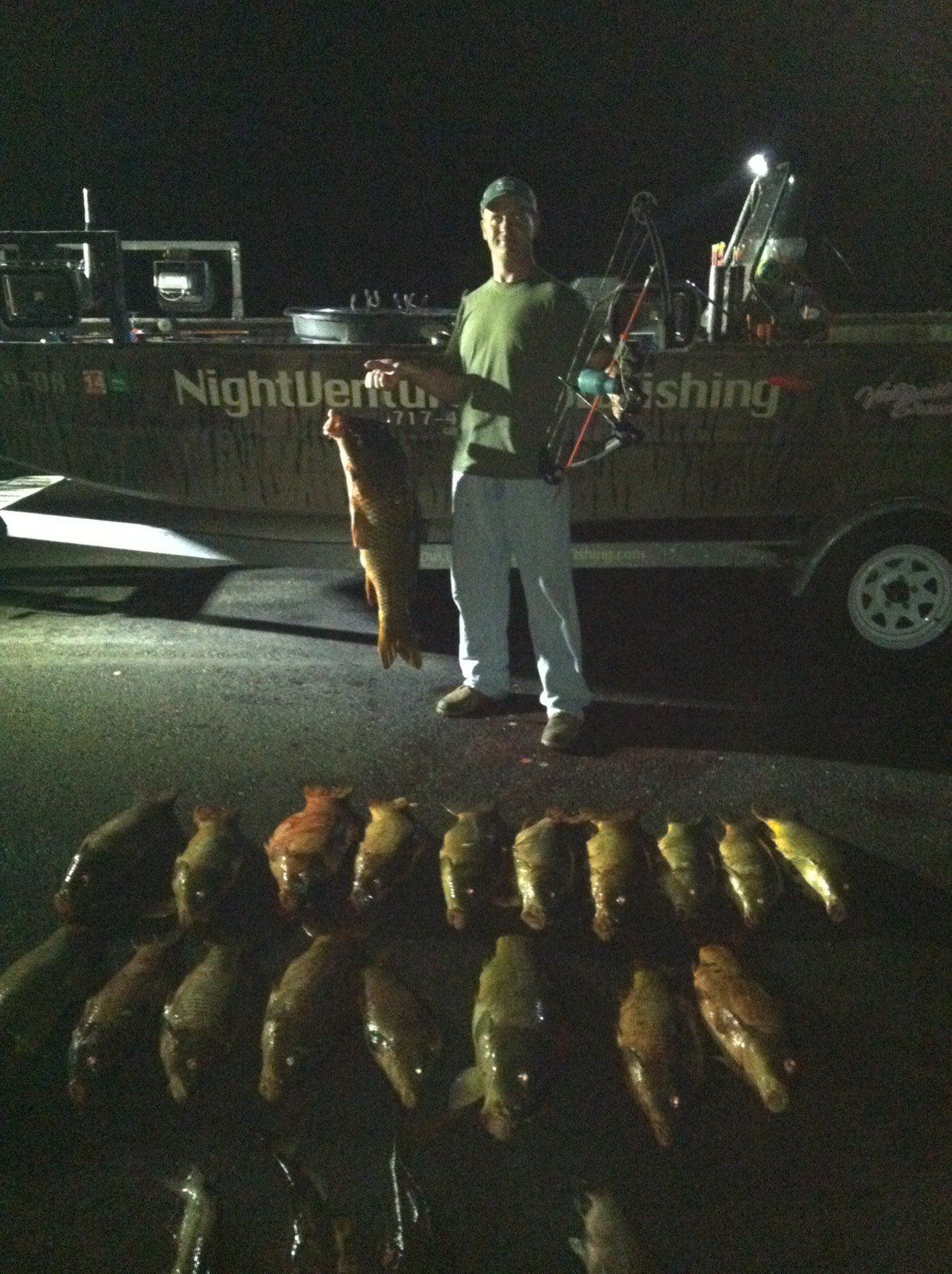 Man Holding a Fish in a Hook and a Bow — Lancaster County, PA — Night Ventures Bowfishing Charters