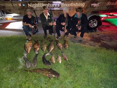 Bowfishing Charters — Four Men with their Fishes Laying on Grass in Lancaster County, PA