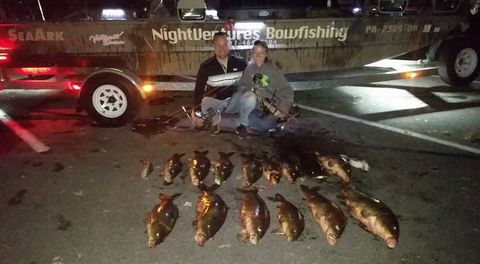 Night Bowfishing — Couple with the Carp Fish on Ground in Lancaster County, PA