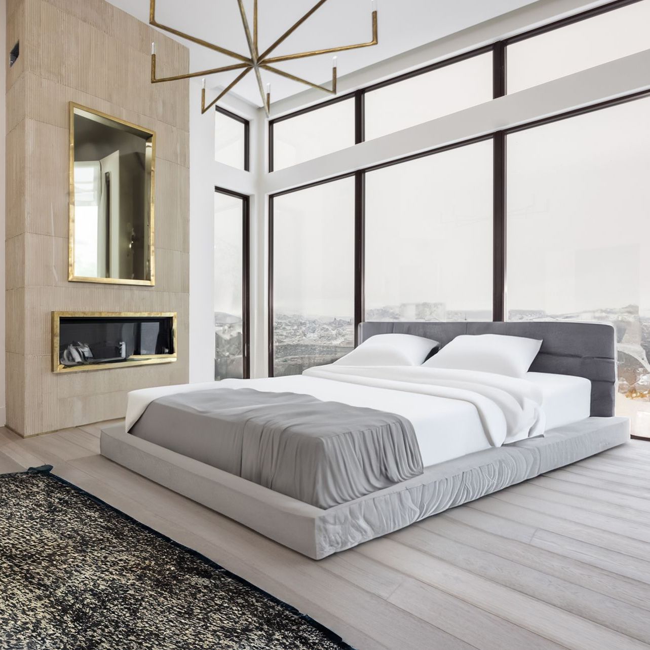 A modern bedroom with a bed near large windows and a fireplace.