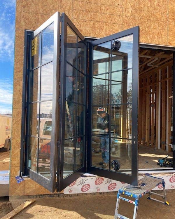 a Sun Glass employee standing in front of a door installed by Sun Glass
