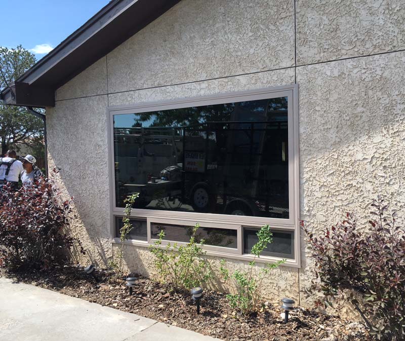 a large window installed by Sun Glass on the side of a building 