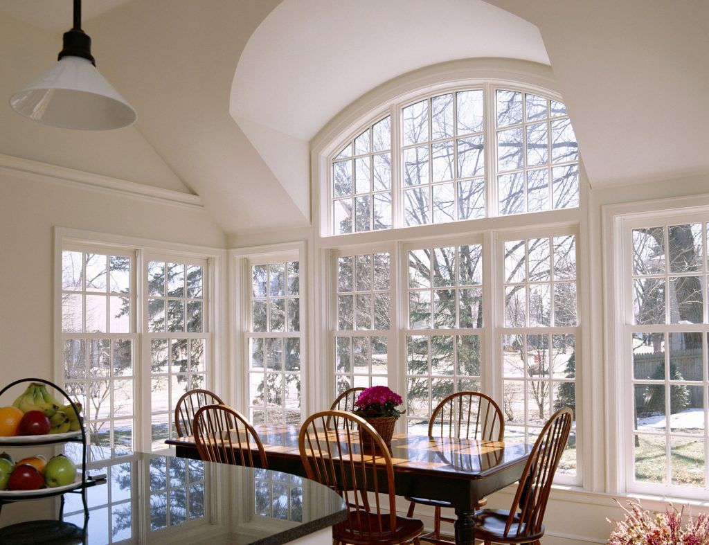 Dining room with white framed windows installed by Sun Glass