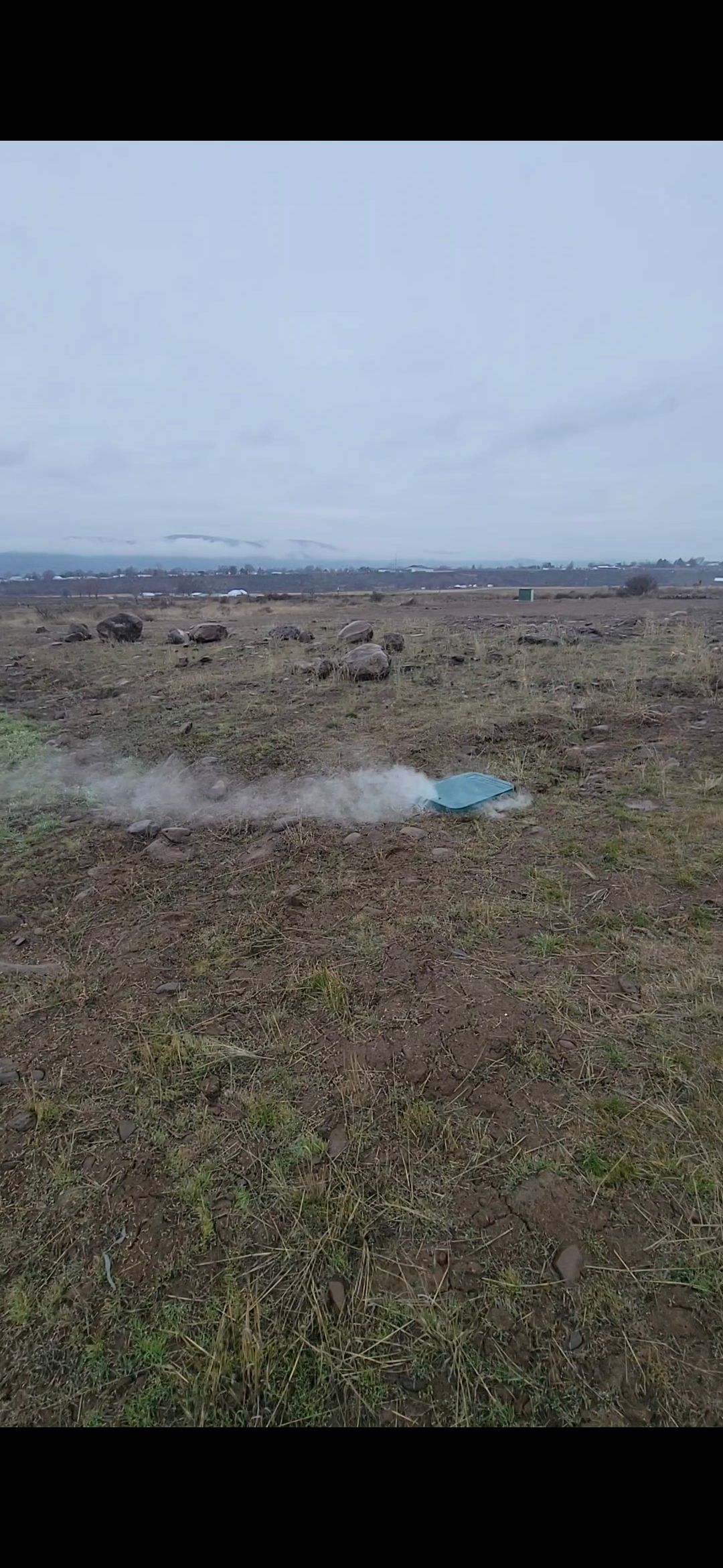 A man in a green shirt is working on a machine