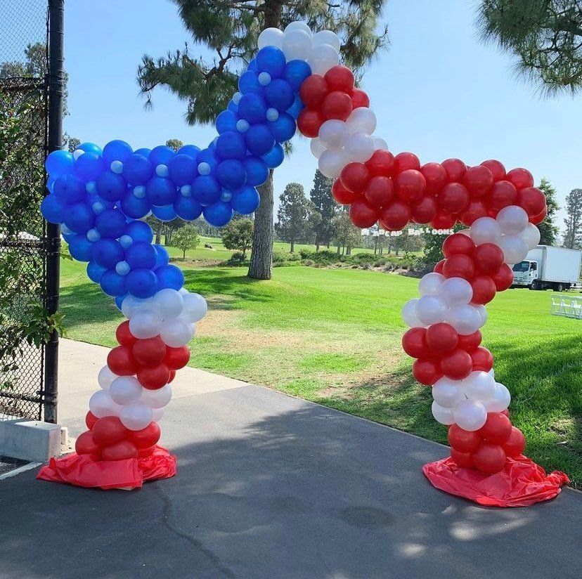 Red, white, and blue balloon arch shaped like a square