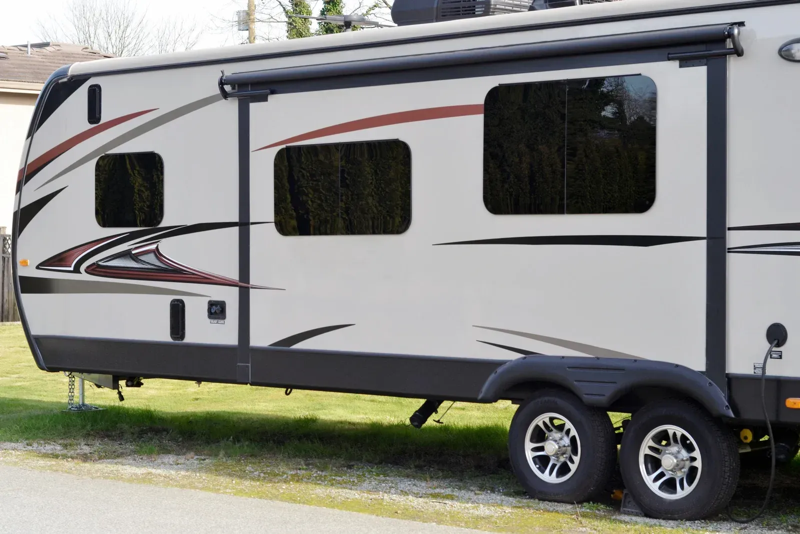 A white rv is parked on the side of the road