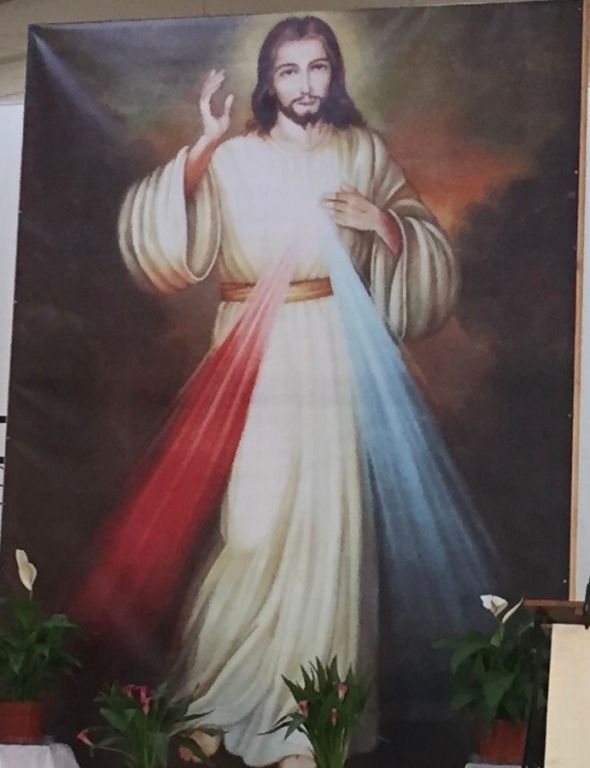 Painting of Jesus with a serene expression, in a white robe.