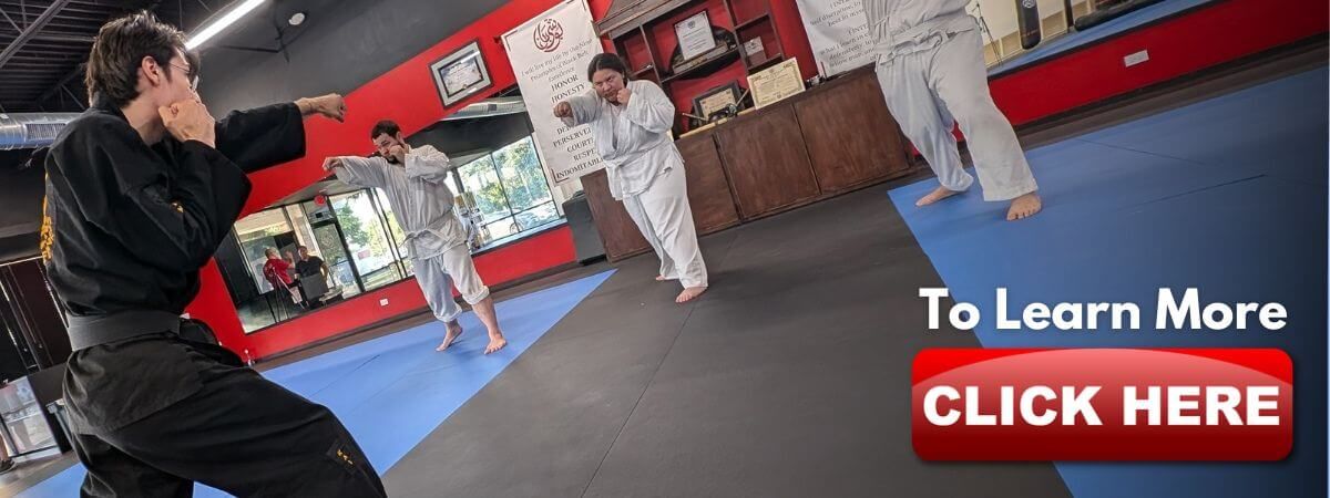 Sensei Kailer teaching a group of teenagers how to punch