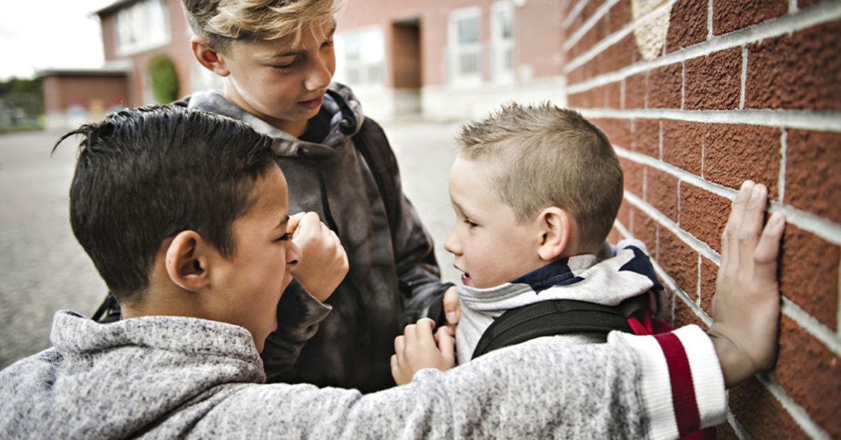 Group of boys bullying another boy