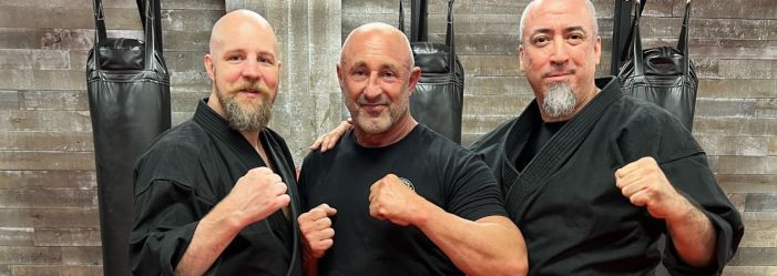 Three over 40-year-old black belt men posing for a picture