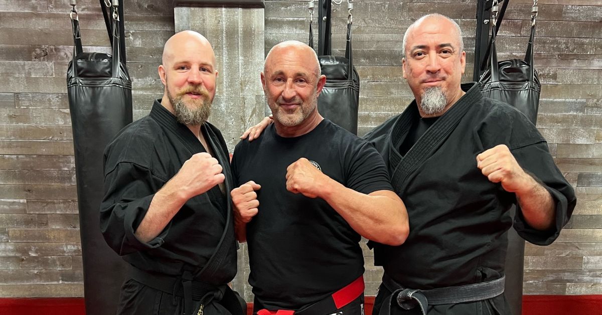 black belt men over 40 posing for a picture