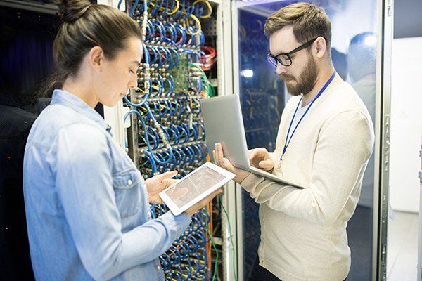 man and woman standing in front of wires