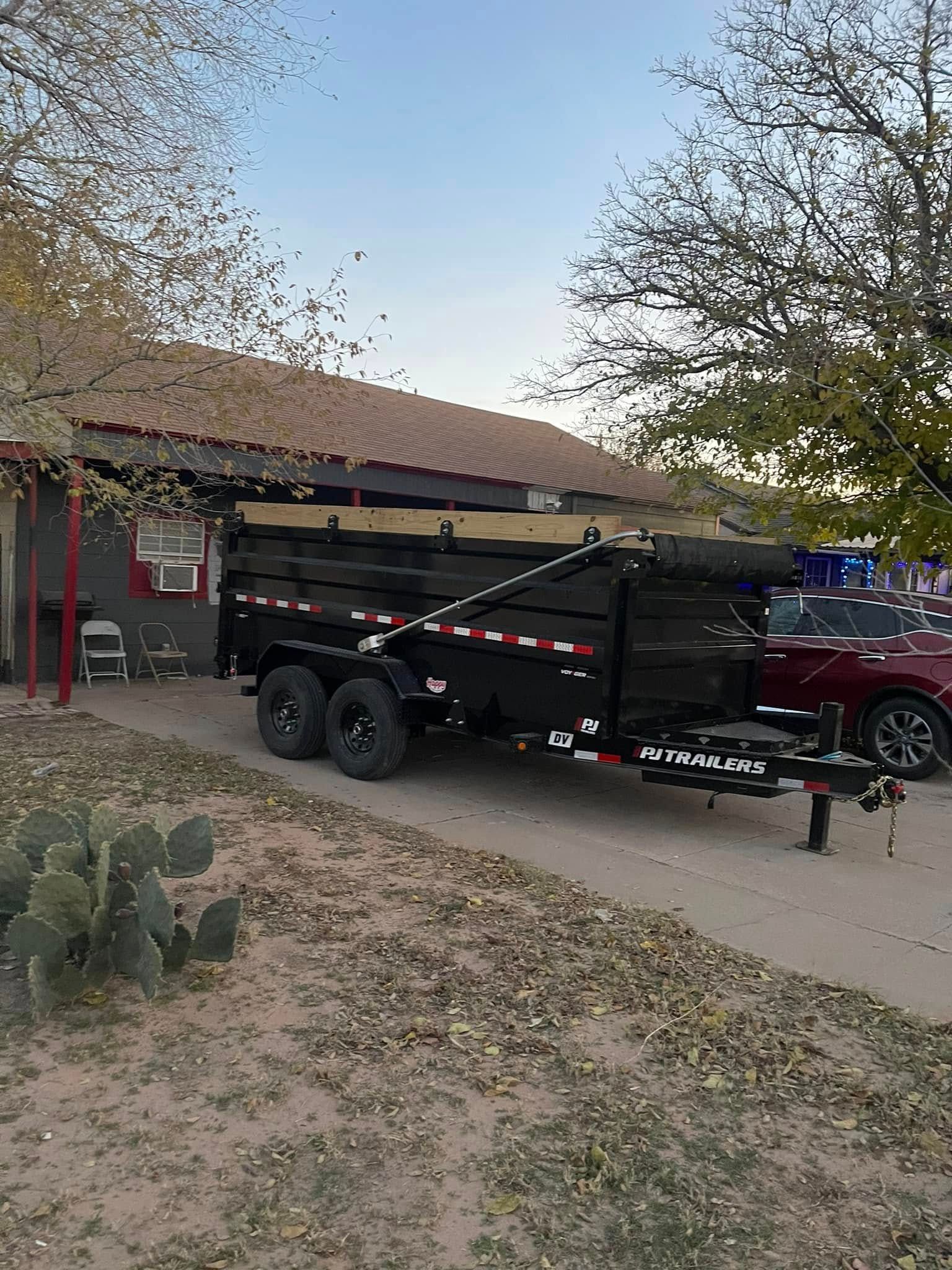 A dump truck is parked in front of a house.
