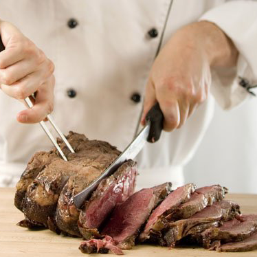 Chef carving beef