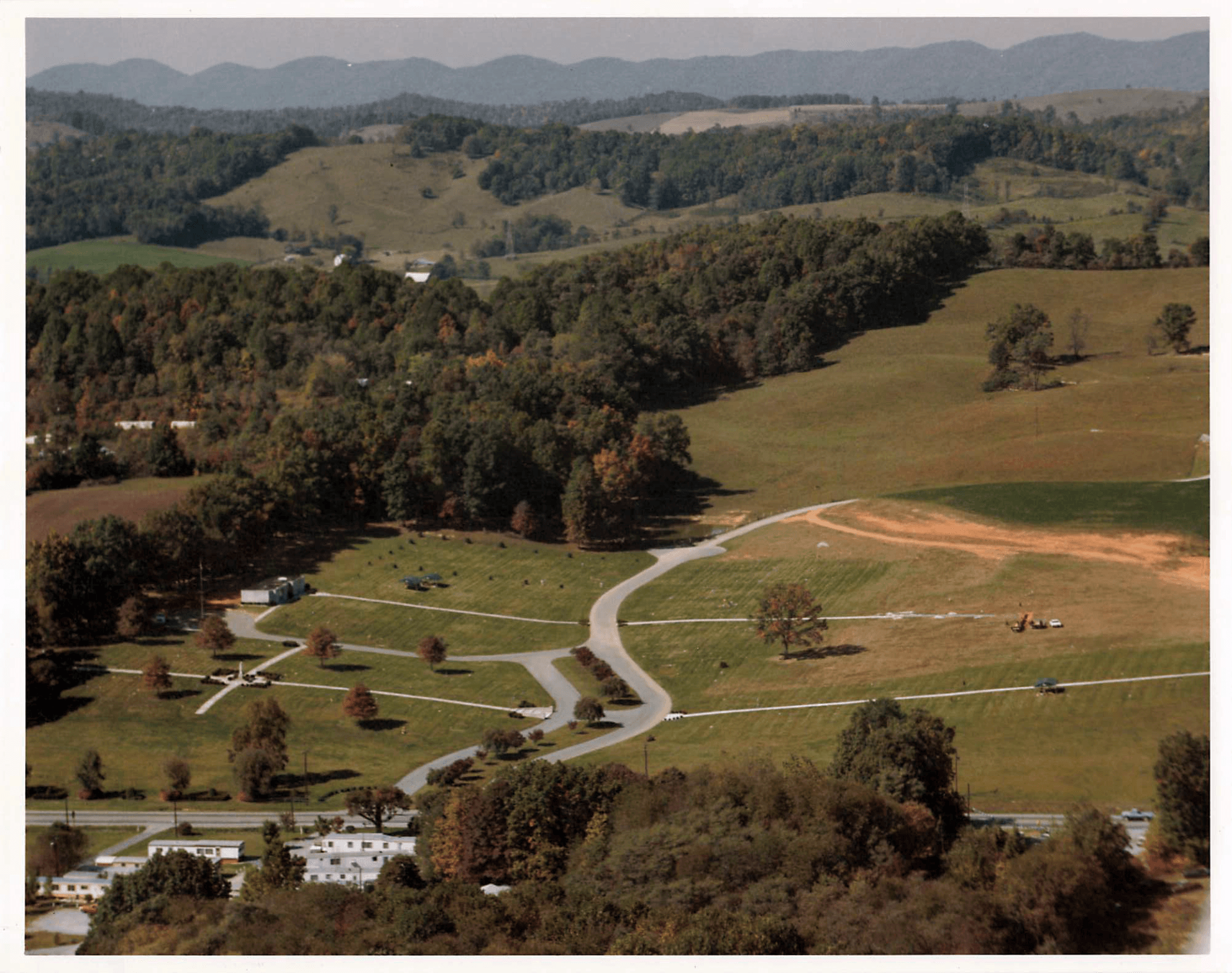 An aerial view of a valley with mountains in the background