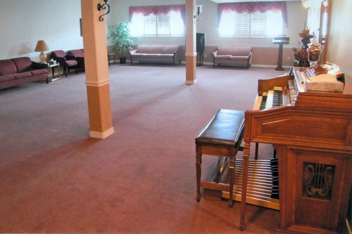 A living room with a piano and a bench