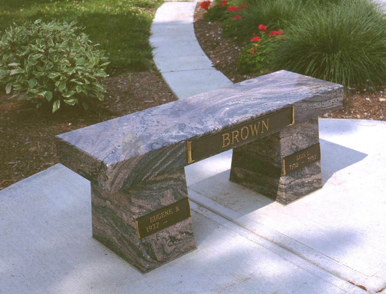 A stone bench with the name brown on it