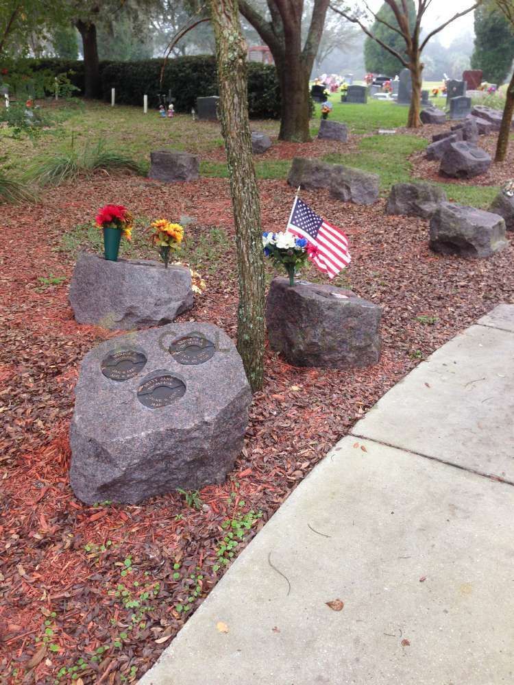 A cemetery with a lot of rocks and flowers