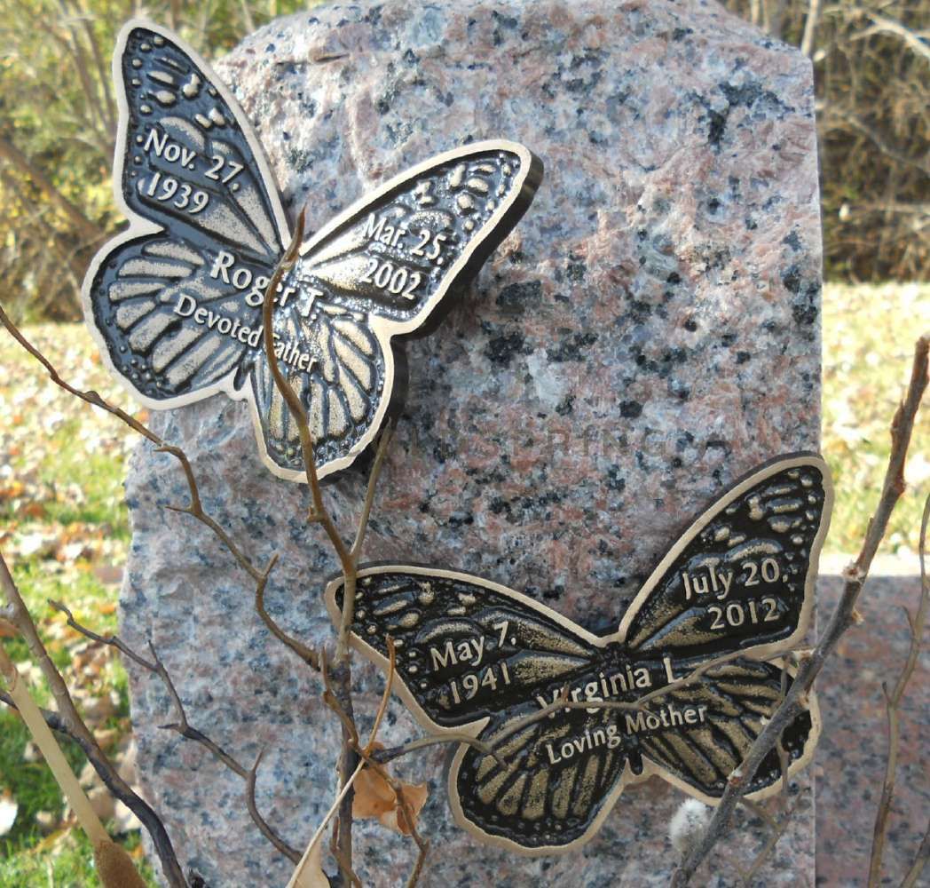 A gravestone with two butterflies on it and the date nov 27 1939
