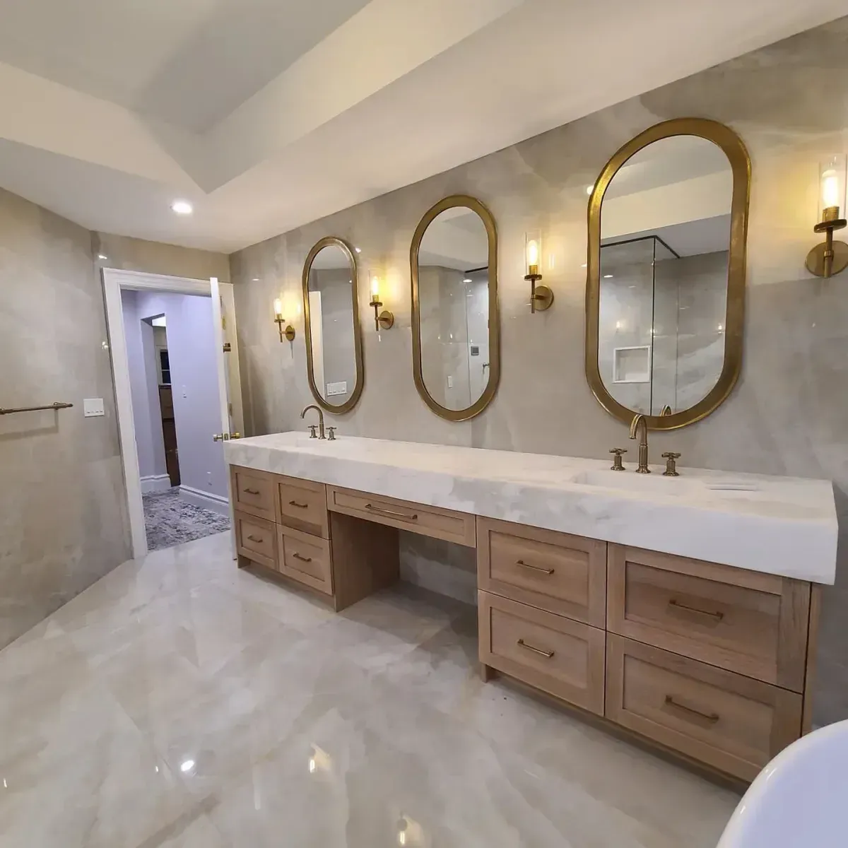 A bathroom with two sinks and three mirrors