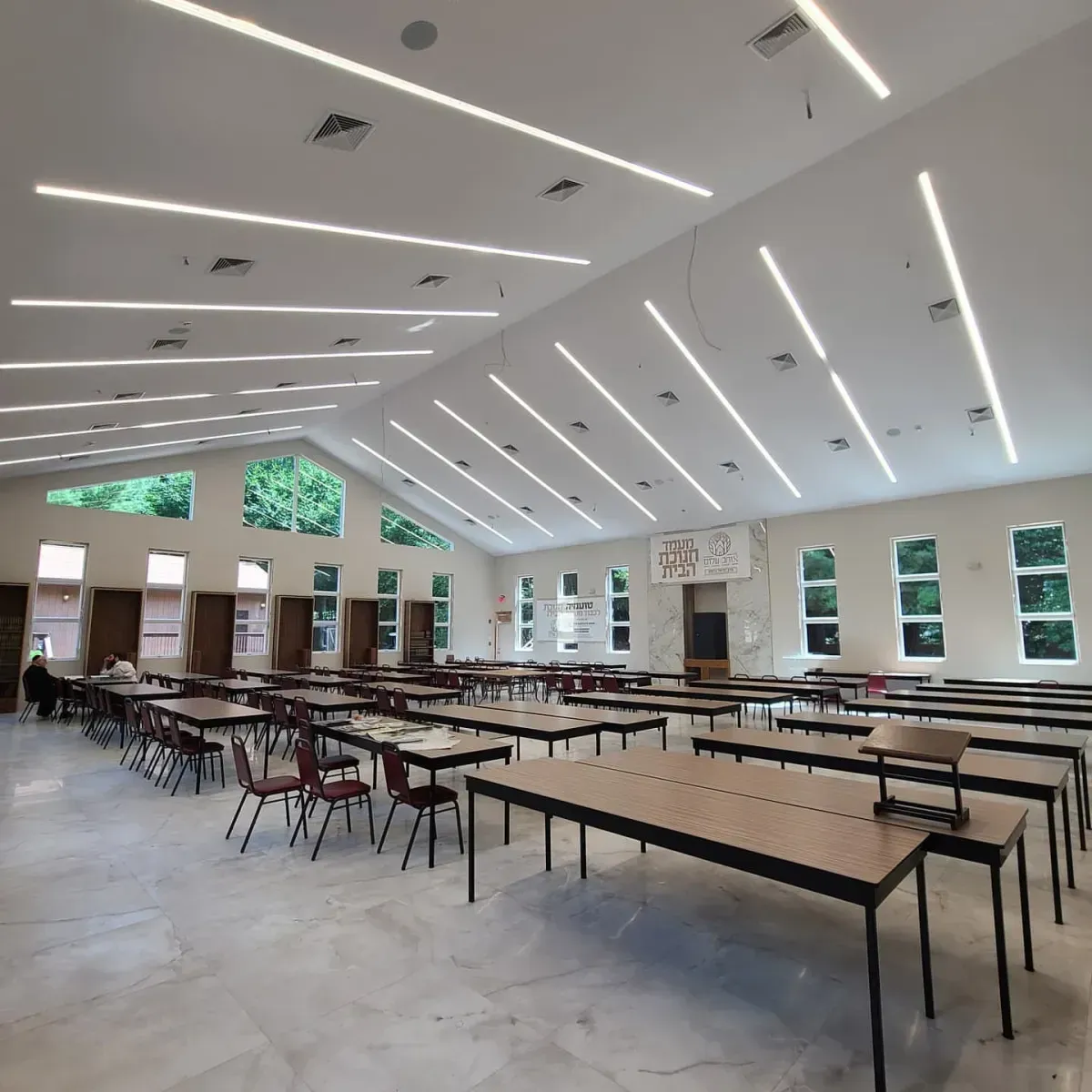 A large room with lots of tables and chairs