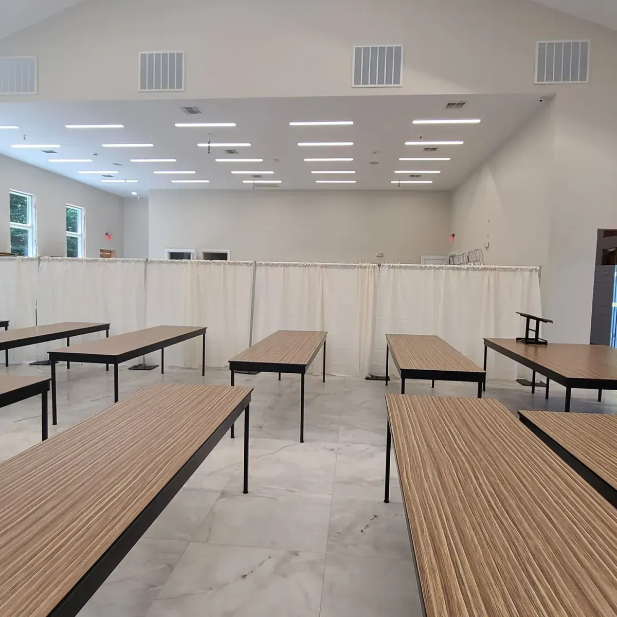 A large room with tables and benches in it