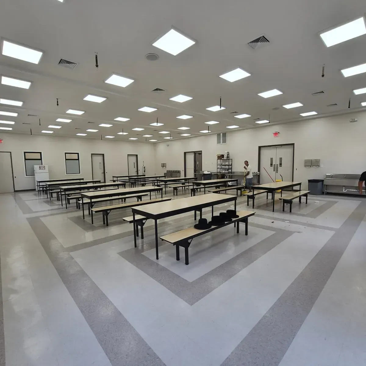 A large room with tables and benches in it