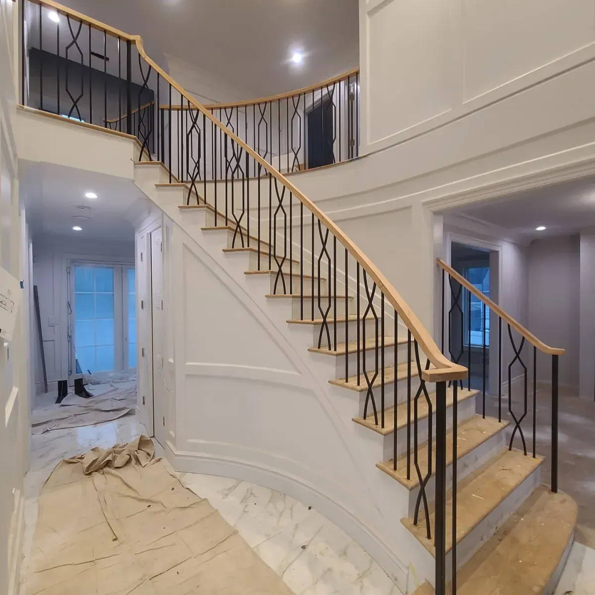 A staircase with a metal railing and wooden steps