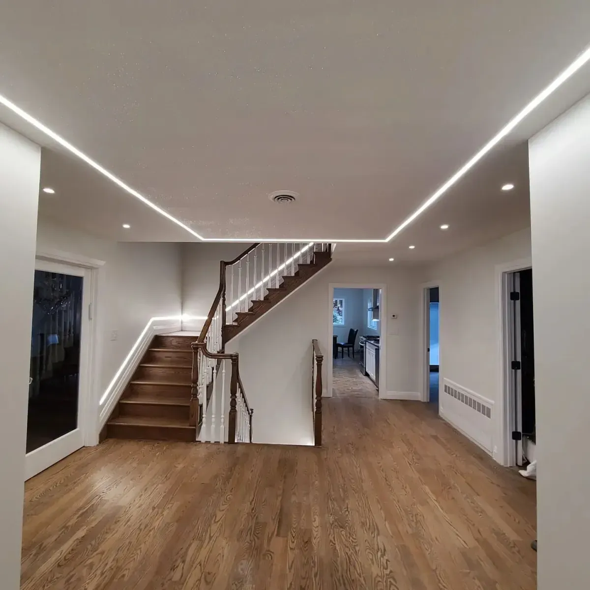A hallway with stairs leading up to the second floor