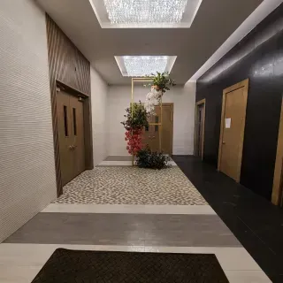 A hallway with a chandelier hanging from the ceiling
