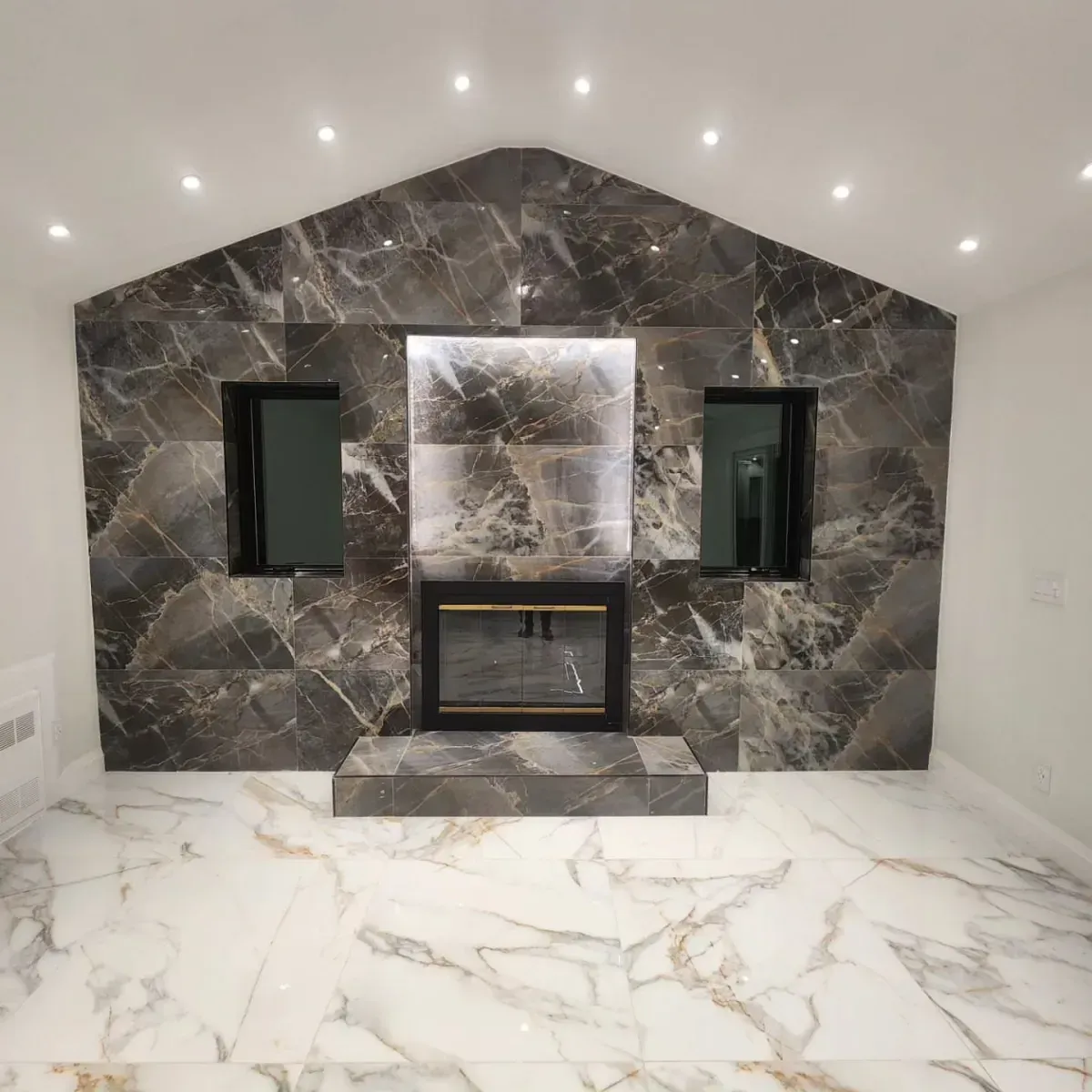 A living room with a fireplace and a marble floor