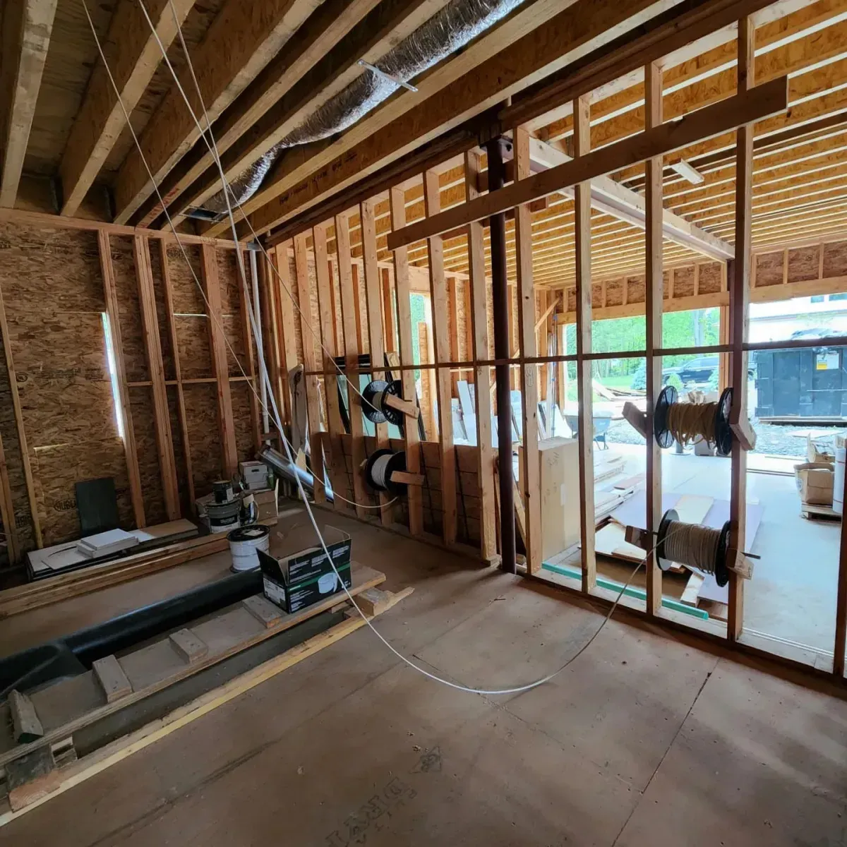 A room with a lot of wooden beams and a lot of windows.
