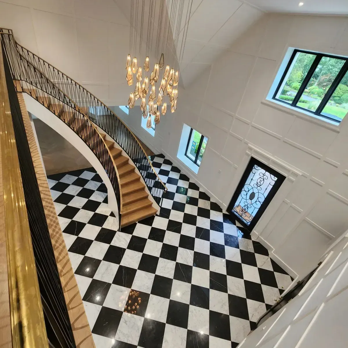 A black and white checkered floor with a staircase in the background