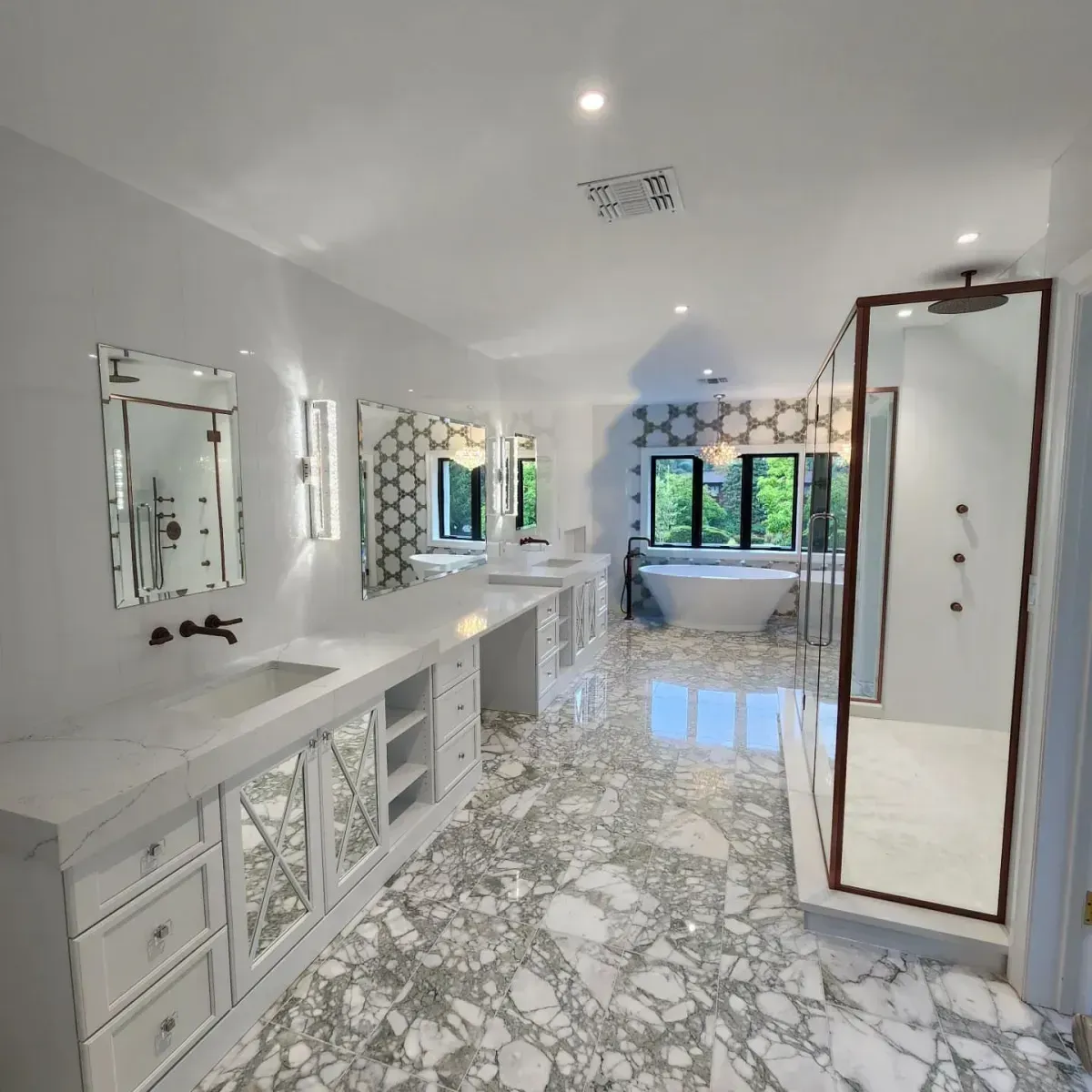 A bathroom with marble floors and a bathtub