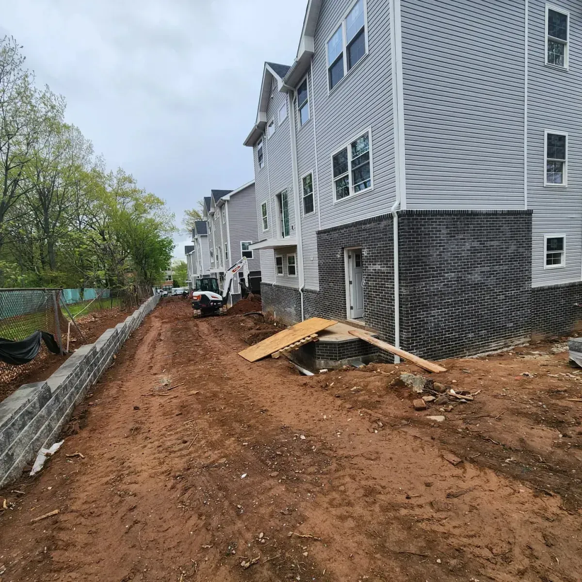 A building is being built next to a dirt road.