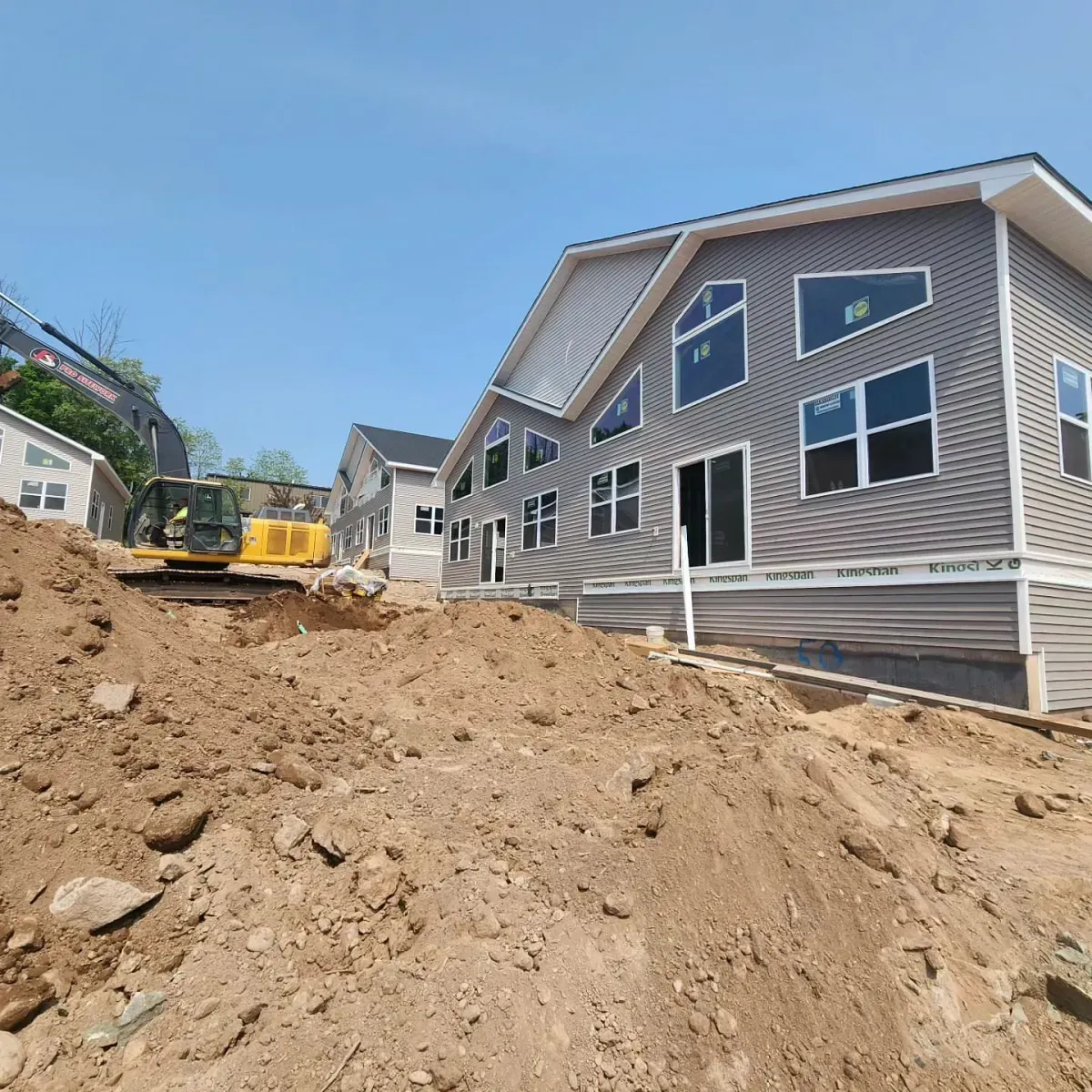 A house is being built on top of a dirt hill