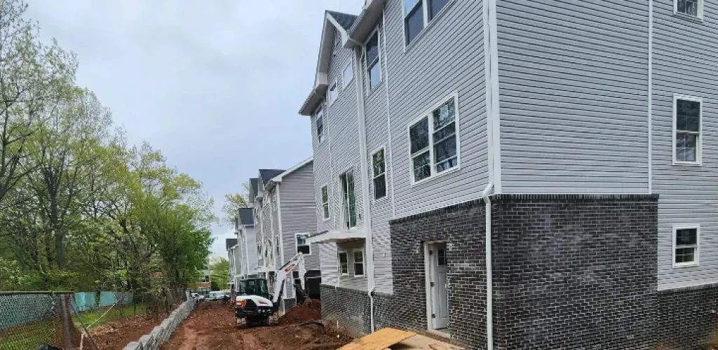 A large white building with a lot of windows is being built.