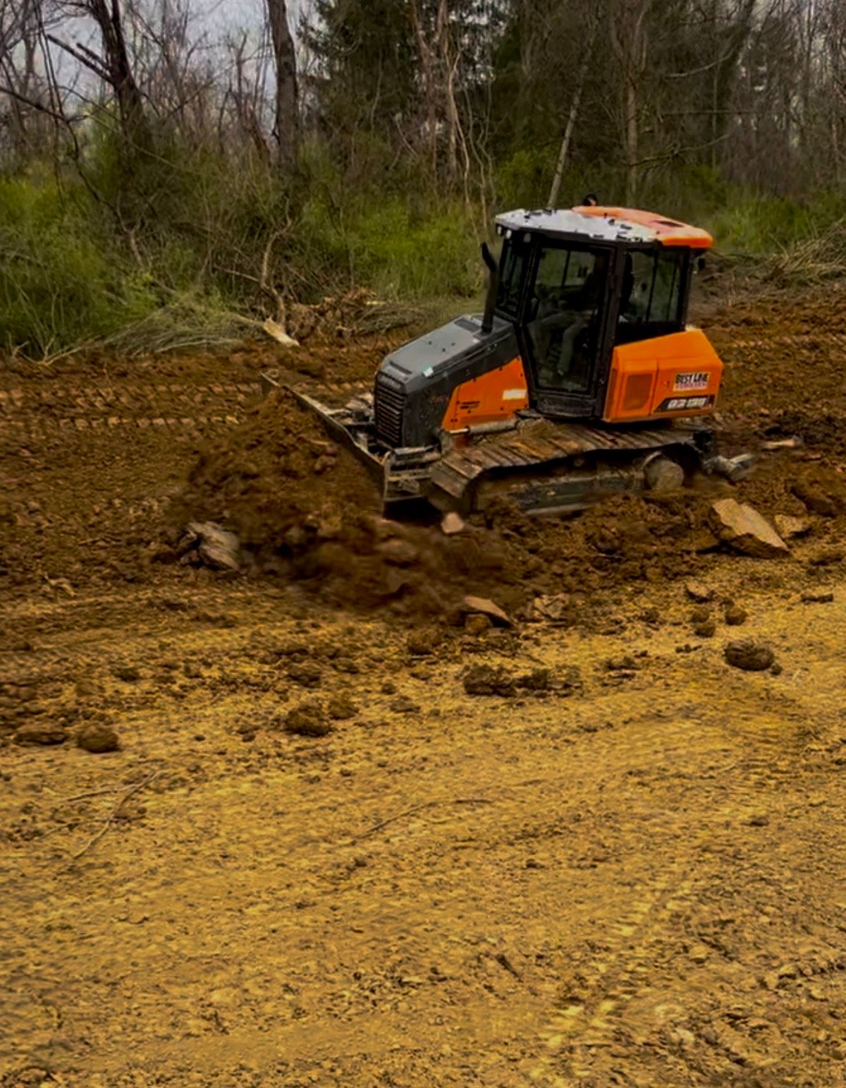 A group of men are laying asphalt on a road.