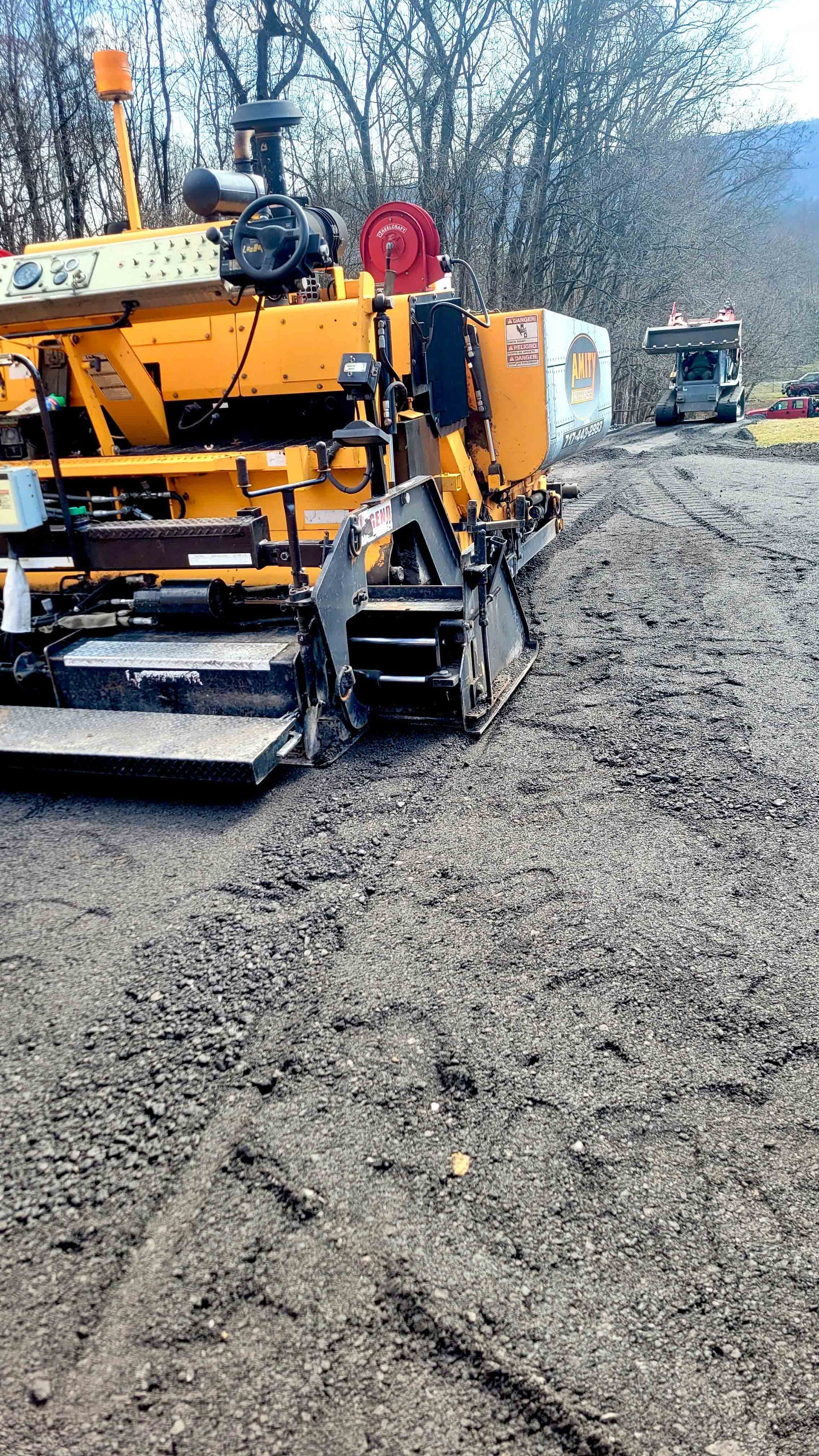 A roller is rolling asphalt on a road.