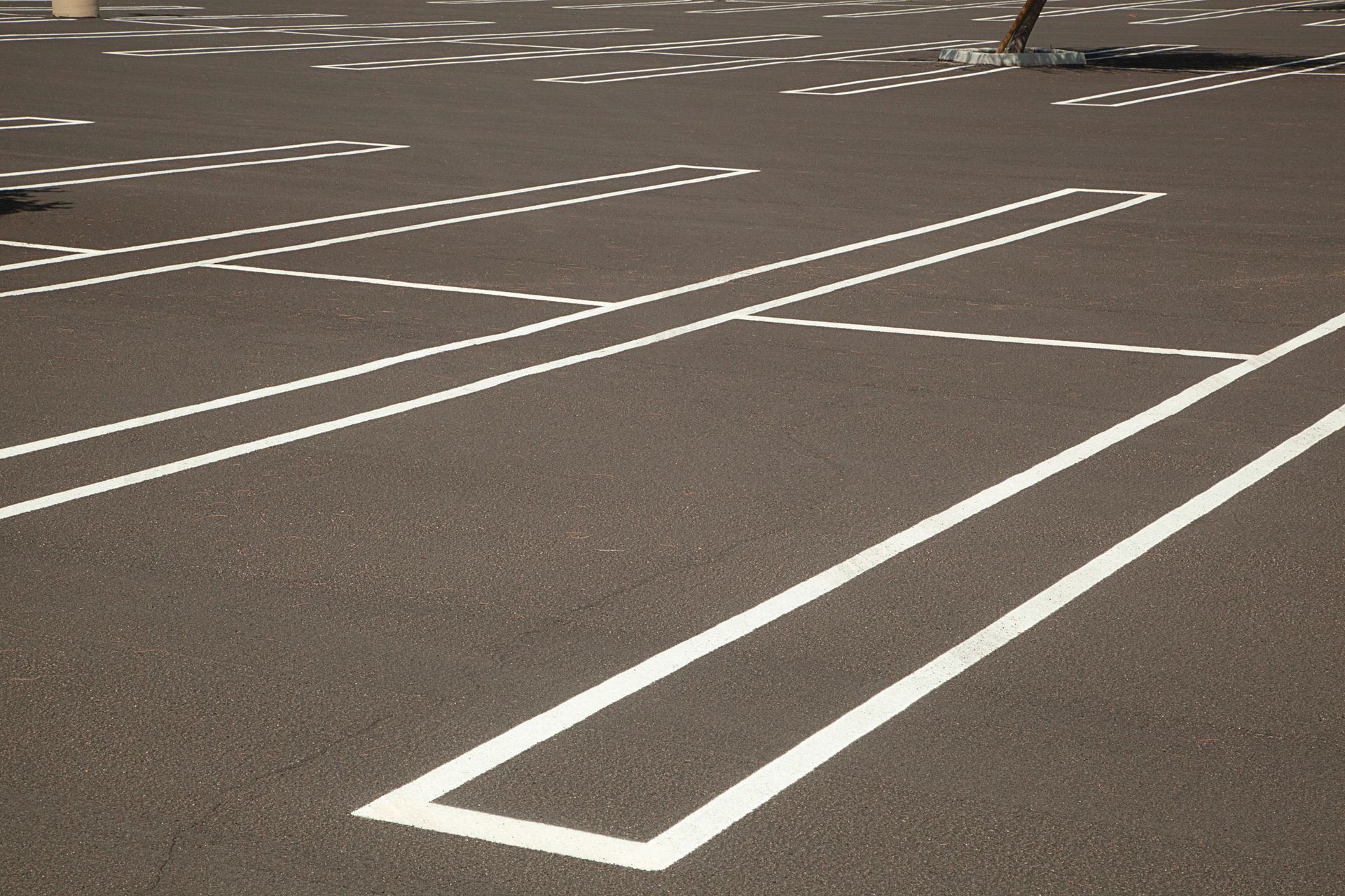 A parking lot with white lines on the asphalt.