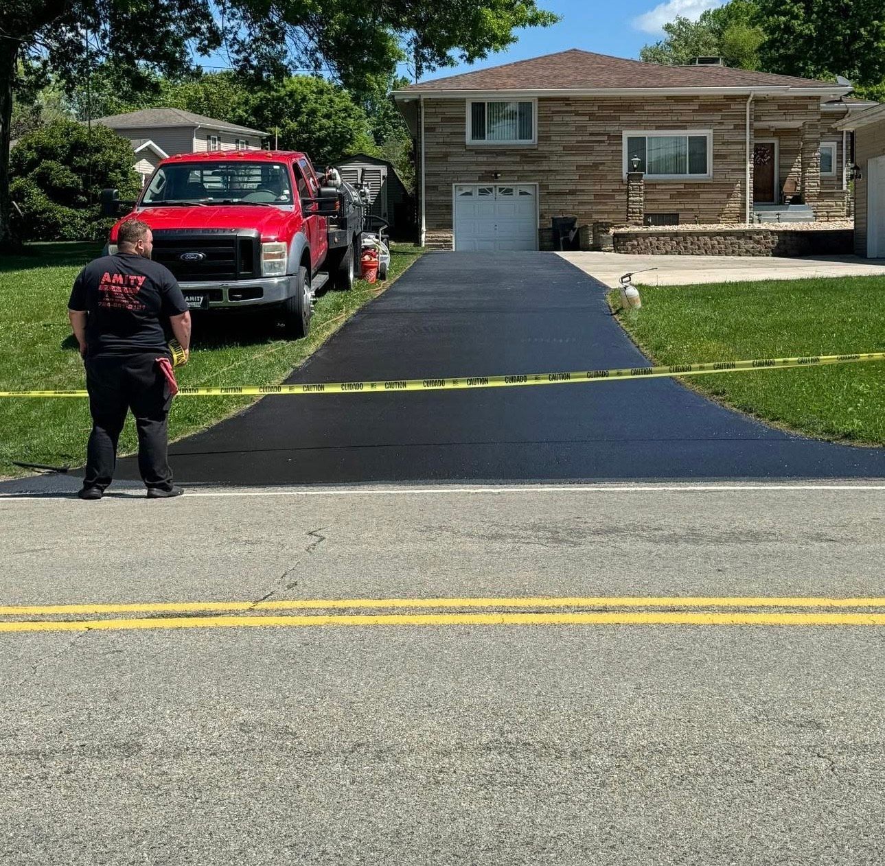 Before a red truck is parked on the side of the road in front of a house.