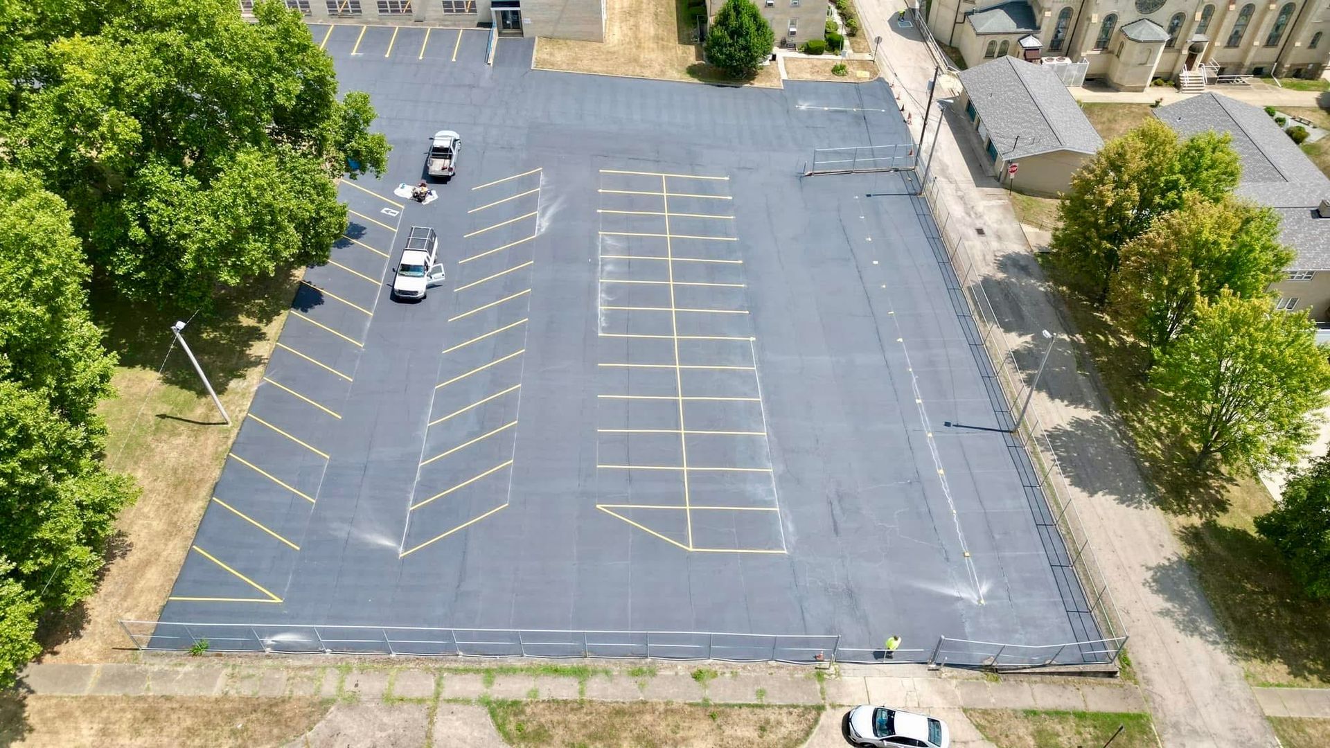 After an aerial view of a parking lot with cars parked in it.