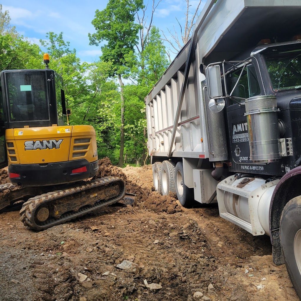 An excavator is loading dirt into a dump truck.