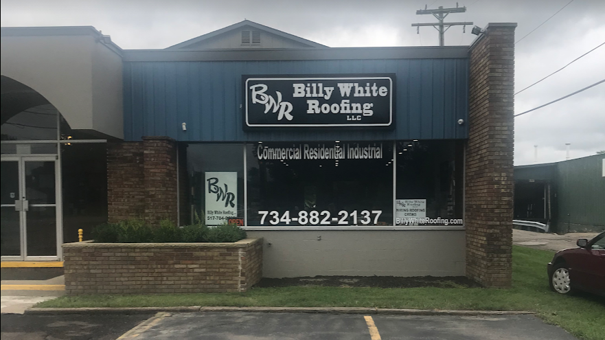 A building with a sign that says billy white roofing