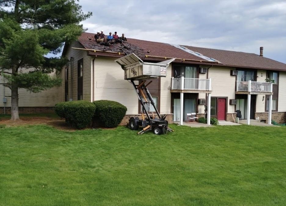 A group of people are working on the roof of a building.
