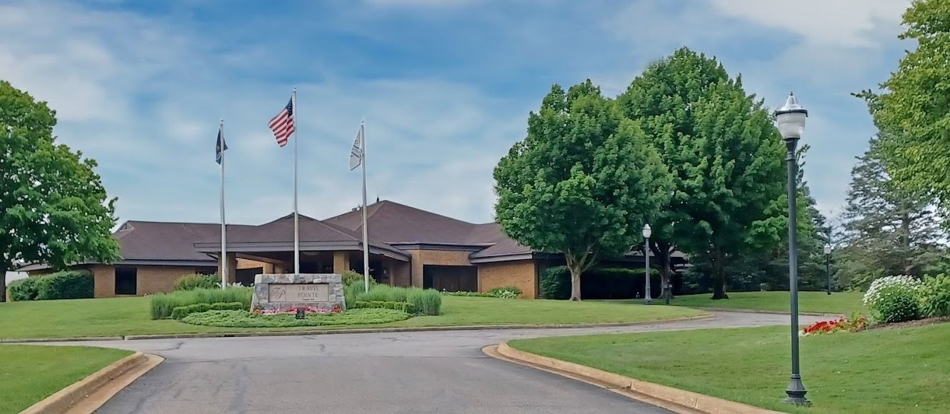 A large house with a lot of trees in front of it.