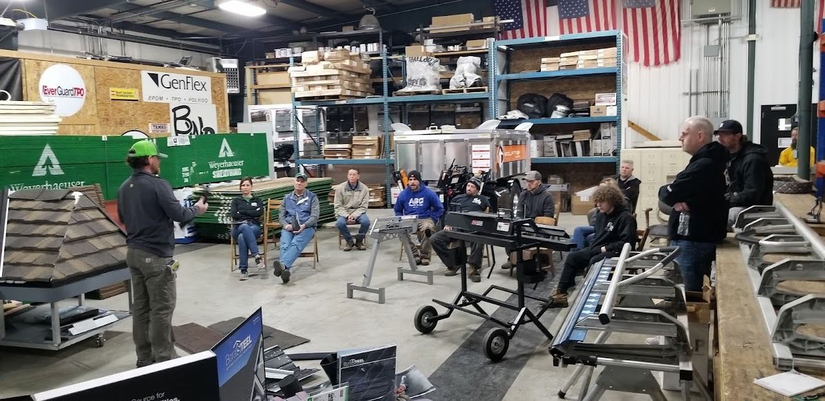 A man is giving a presentation to a group of people in a workshop.