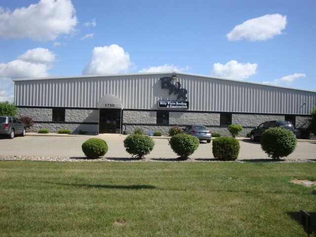 A large building with cars parked in front of it