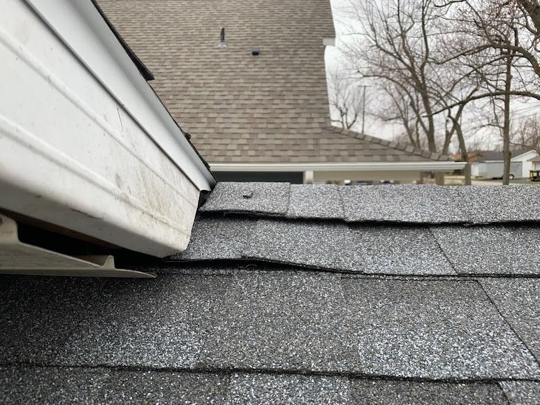 A close up of a roof with a gutter on it.
