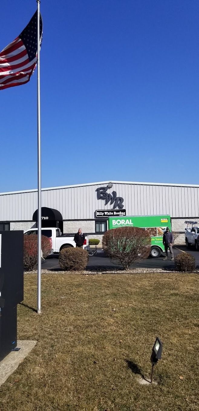An american flag is flying in front of a building.